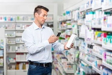 THIRD-COLUMN-Man-scanning-label-of-pharmacy-product-with-mobile-phone-1